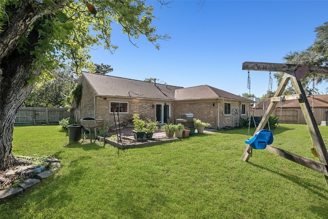 rear view of property featuring a yard