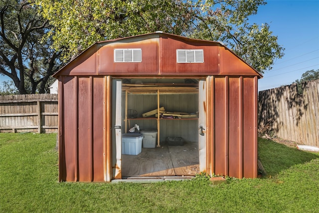 view of outbuilding with a lawn