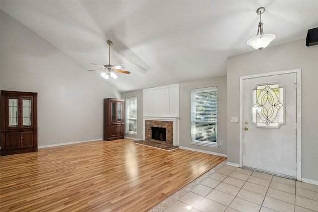 entryway featuring lofted ceiling, a healthy amount of sunlight, light wood-type flooring, and ceiling fan