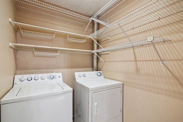 washroom with washing machine and clothes dryer