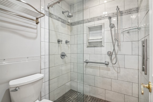 bathroom with toilet and a shower with shower door