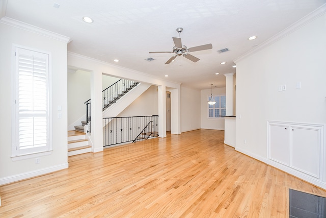 unfurnished living room featuring light wood-type flooring, ceiling fan, and crown molding