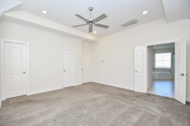 spare room with ceiling fan, light colored carpet, and ornamental molding