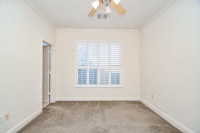 carpeted empty room featuring a textured ceiling, ceiling fan, and ornamental molding