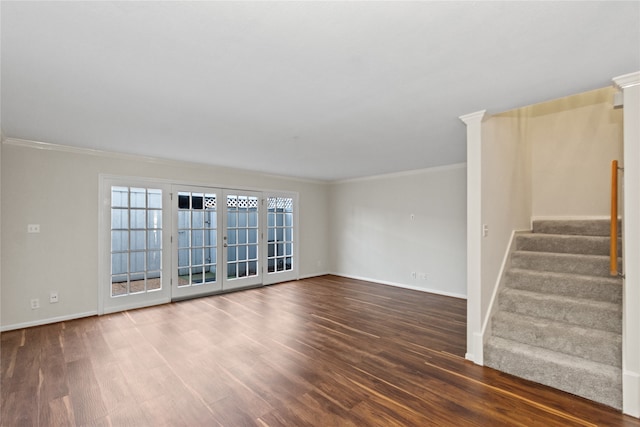 empty room featuring dark hardwood / wood-style flooring, ornate columns, and crown molding