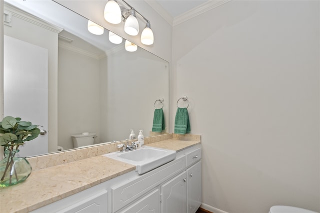 bathroom with vanity, toilet, and ornamental molding