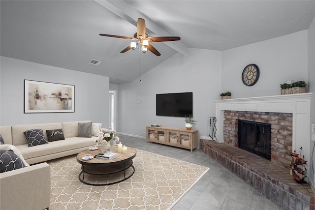 living room featuring lofted ceiling with beams, ceiling fan, and a brick fireplace