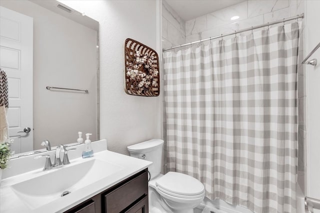 full bathroom featuring shower / bath combo, vanity, and toilet