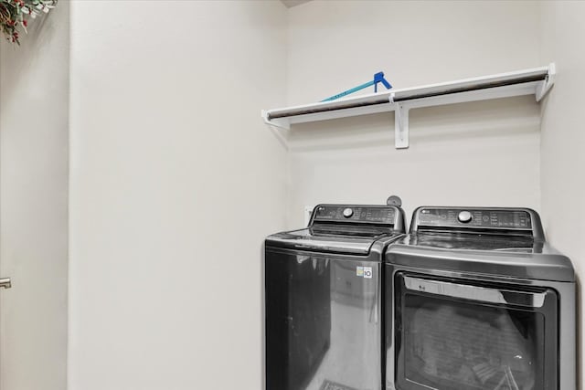 clothes washing area with washing machine and clothes dryer