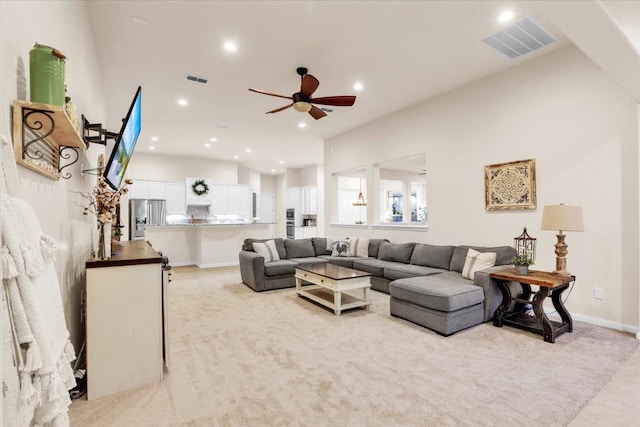 living room with light carpet and ceiling fan