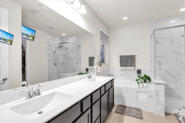 bathroom featuring shower with separate bathtub, vanity, and tile patterned floors