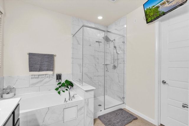 bathroom featuring plus walk in shower and vanity