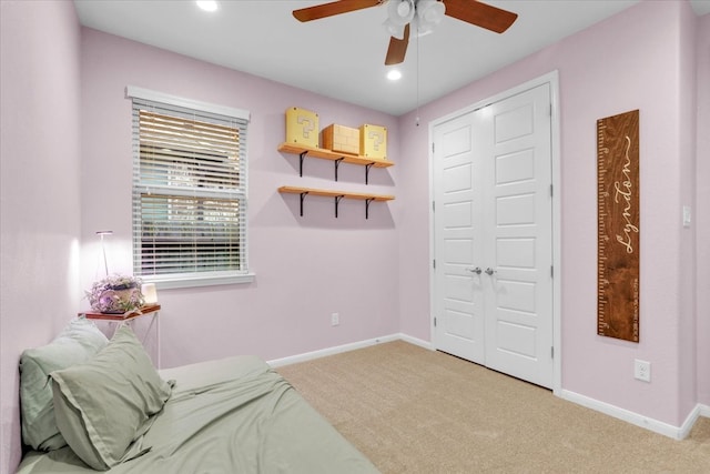 living area featuring carpet flooring and ceiling fan