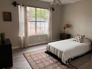 bedroom with ceiling fan and light wood-type flooring