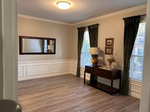 interior space with hardwood / wood-style flooring and ornamental molding