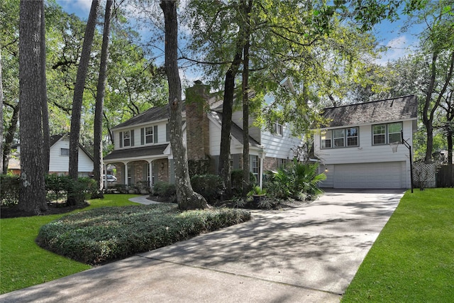 view of front of home with a garage and a front lawn