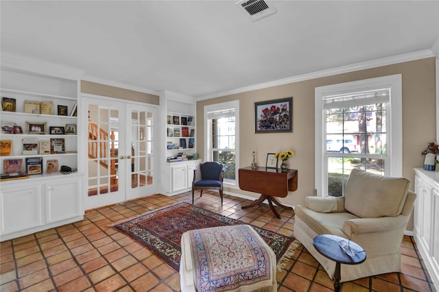 living area featuring built in shelves, crown molding, french doors, and light tile patterned floors