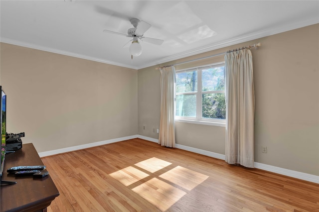 unfurnished office with ceiling fan, light wood-type flooring, and crown molding