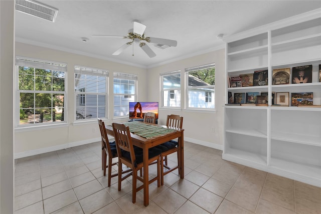 dining area featuring ceiling fan, ornamental molding, and light tile patterned flooring