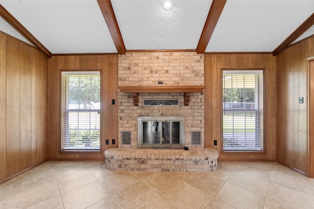 unfurnished living room featuring wood walls and lofted ceiling with beams