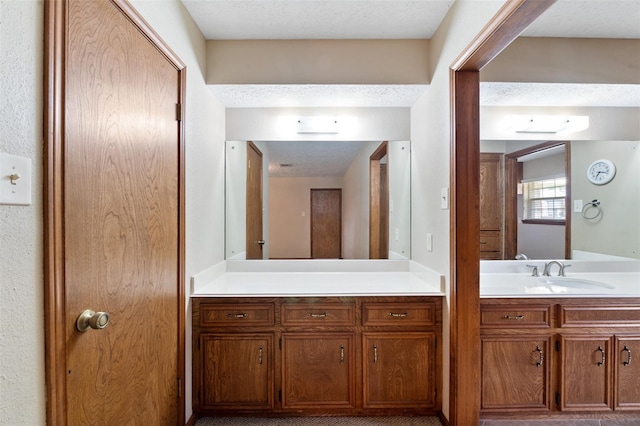 bathroom with vanity and a textured ceiling