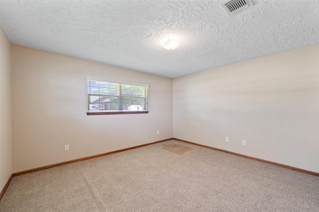 empty room featuring carpet flooring and a textured ceiling