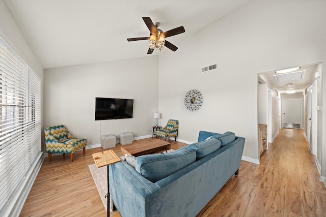 living room featuring light wood-style floors, baseboards, a ceiling fan, and visible vents