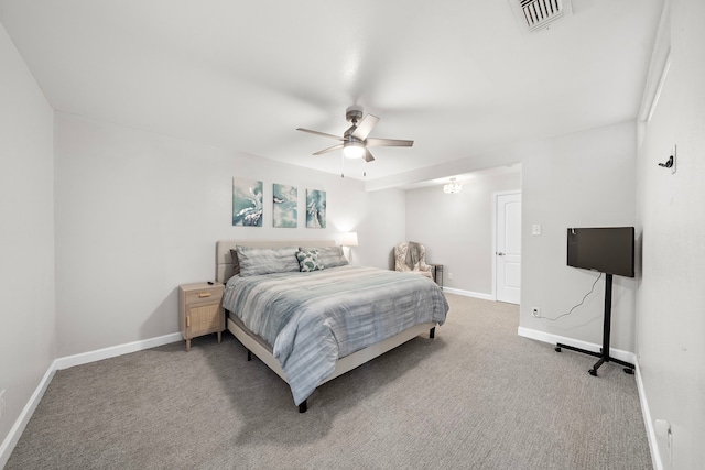 carpeted bedroom featuring baseboards, a ceiling fan, and visible vents