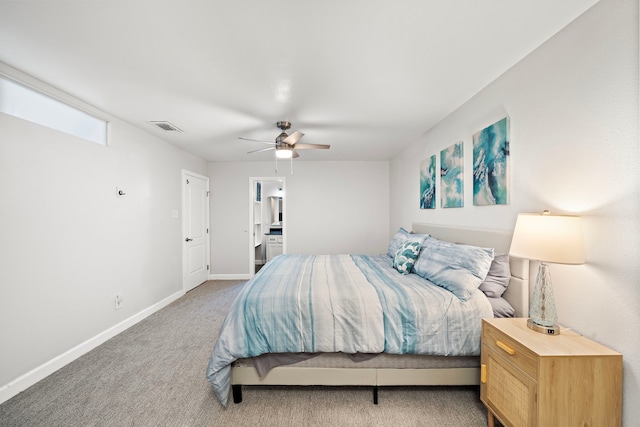 carpeted bedroom featuring ensuite bath, visible vents, baseboards, and ceiling fan
