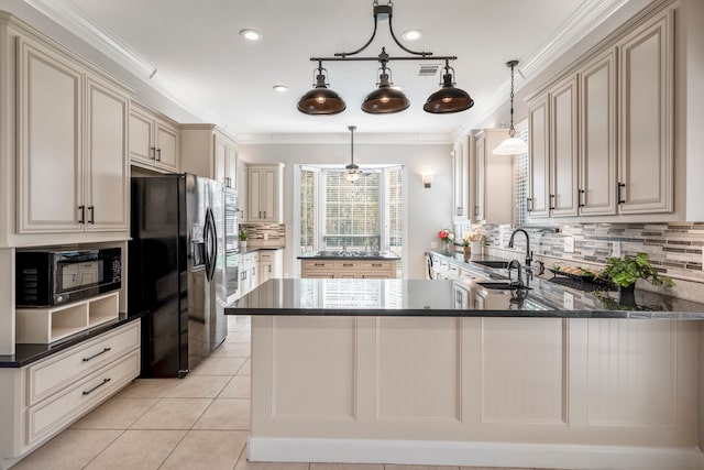 kitchen with kitchen peninsula, pendant lighting, sink, and black appliances