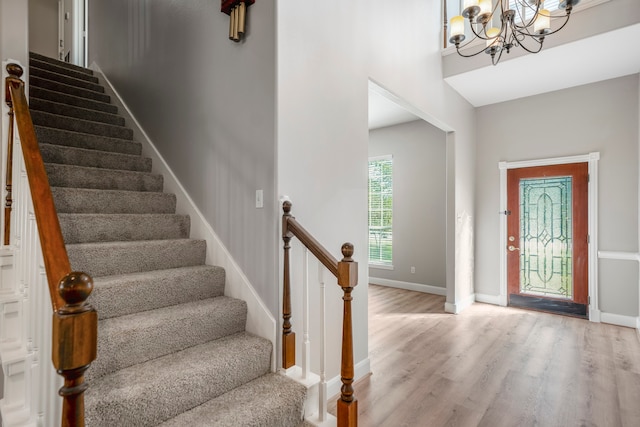 foyer with light hardwood / wood-style floors and an inviting chandelier