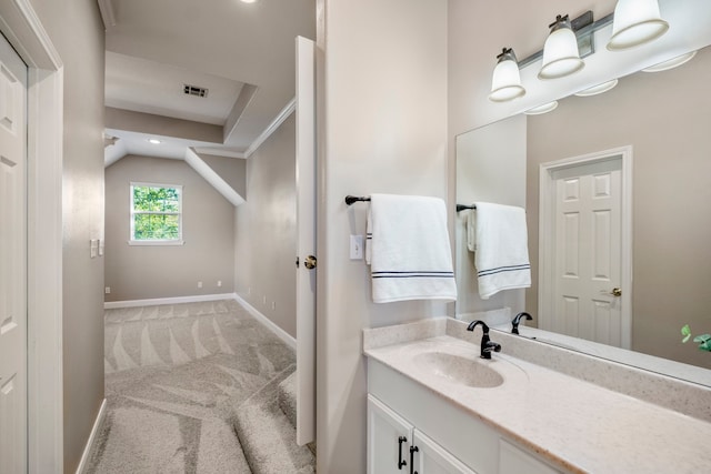 bathroom featuring vanity and lofted ceiling