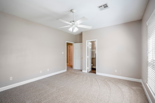 unfurnished bedroom with connected bathroom, ceiling fan, and light carpet