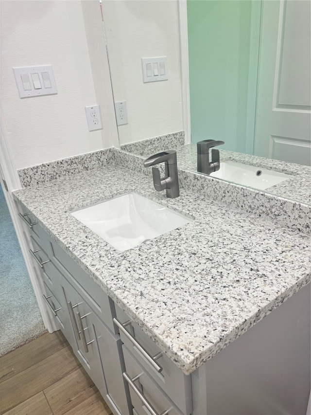 bathroom with vanity and hardwood / wood-style flooring