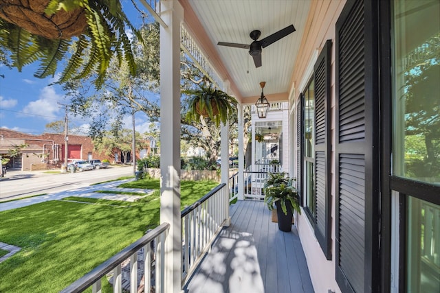 balcony with a porch and ceiling fan