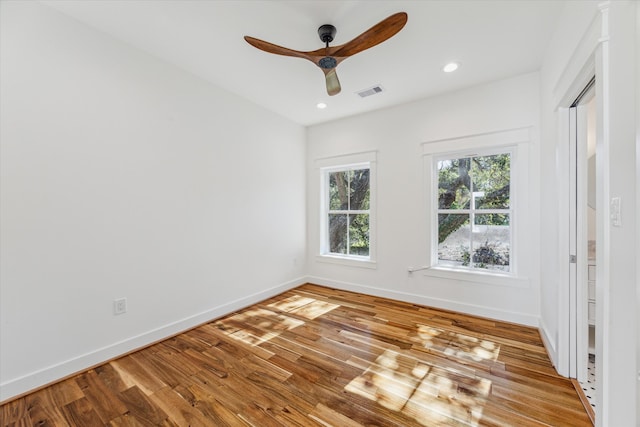 unfurnished room with ceiling fan and light wood-type flooring