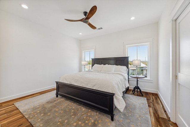 bedroom with ceiling fan and dark wood-type flooring