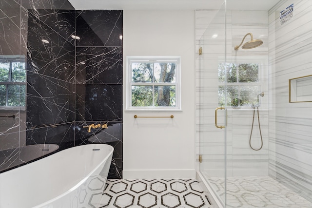 bathroom featuring tile patterned floors, separate shower and tub, and tile walls