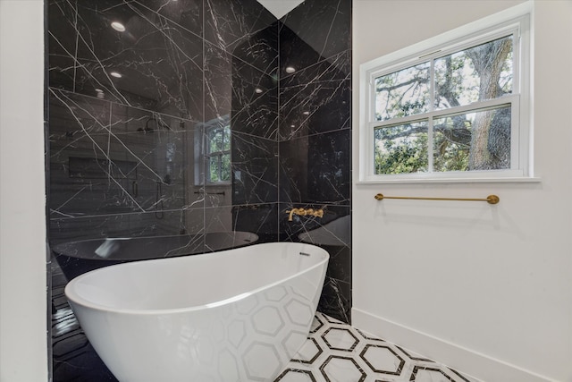 bathroom featuring a bathtub and tile walls