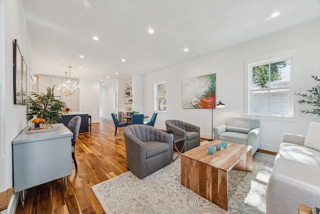 living room featuring light hardwood / wood-style flooring and a chandelier