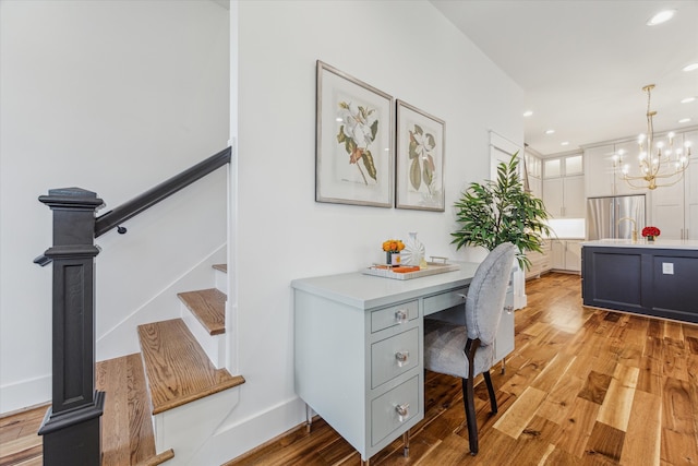 office featuring a notable chandelier and light wood-type flooring