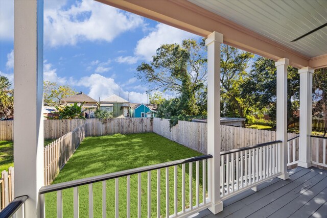 wooden terrace with a lawn