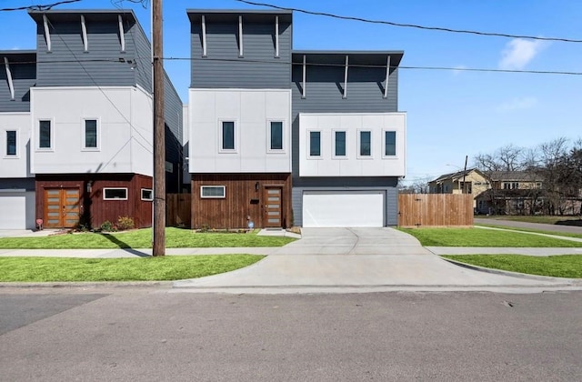 view of front of house featuring a garage and a front yard