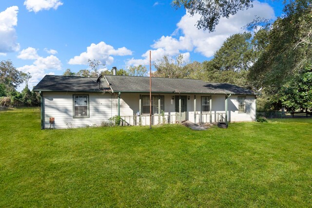 rear view of property with a lawn and covered porch