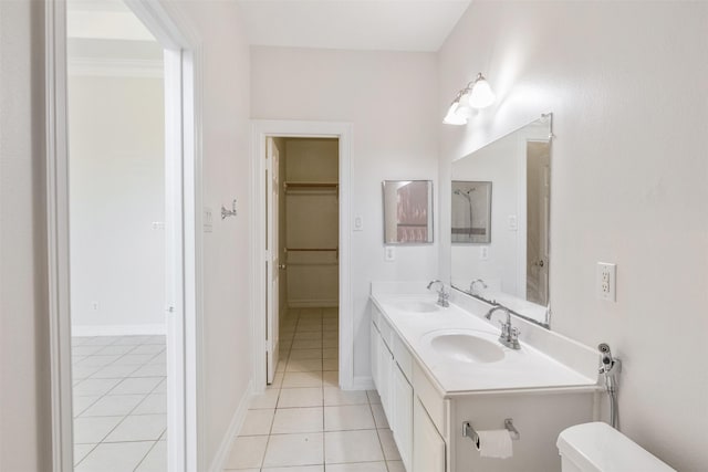 bathroom with tile patterned flooring, vanity, and toilet