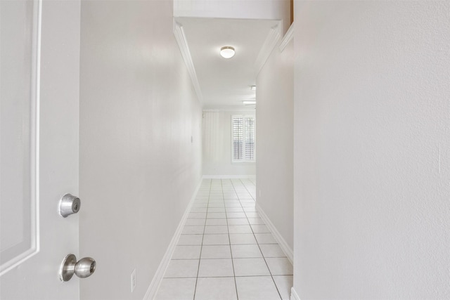 hall featuring ornamental molding and light tile patterned floors