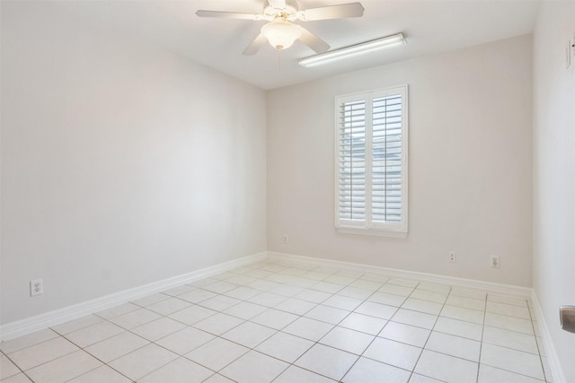 tiled empty room featuring ceiling fan