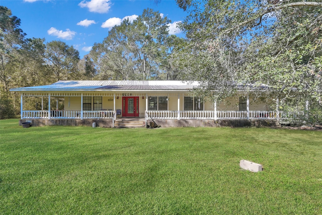 6100 Weir Rd, Cleveland, TX 77328 - farmhouse inspired home with a front lawn and a porch