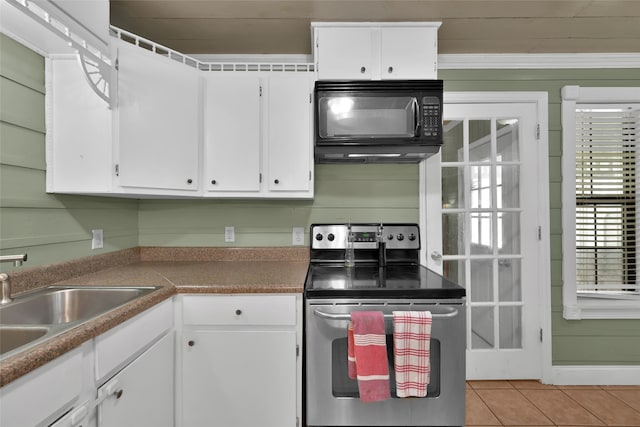 kitchen with white cabinets, electric stove, crown molding, sink, and light tile patterned floors