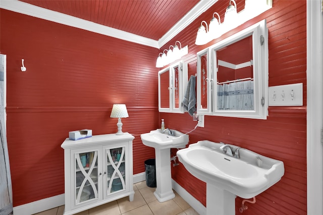 bathroom with tile patterned floors, dual sinks, ornamental molding, and wooden walls